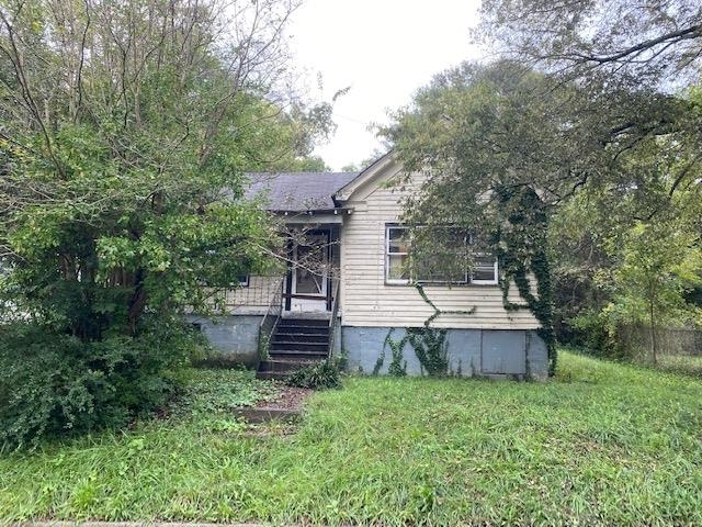 1207 Spring Creek Street Southwest Rome, GA 30161 - Photo 1 of 1 a view of a small house with wooden fence