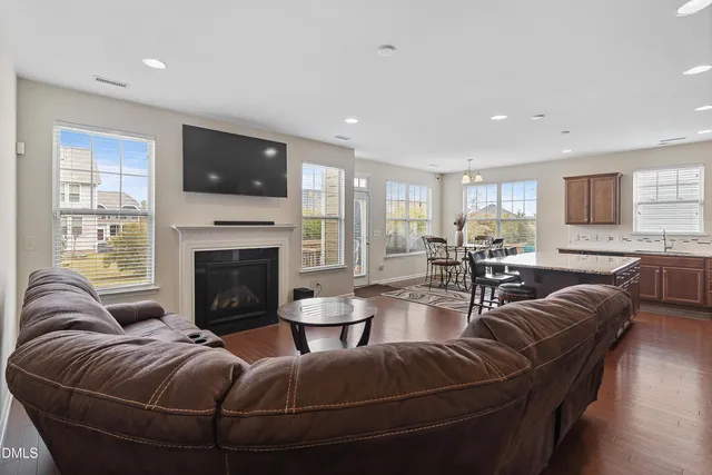 a living room with furniture a fireplace and a flat screen tv