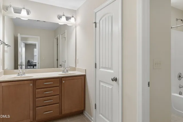 a bathroom with a double vanity sink and mirror