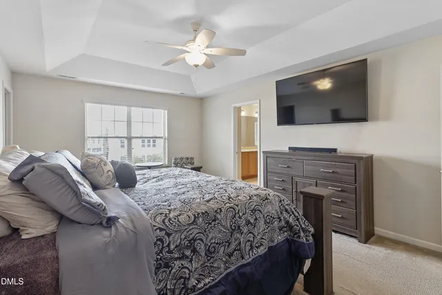 a bedroom with a large bed and flat screen tv