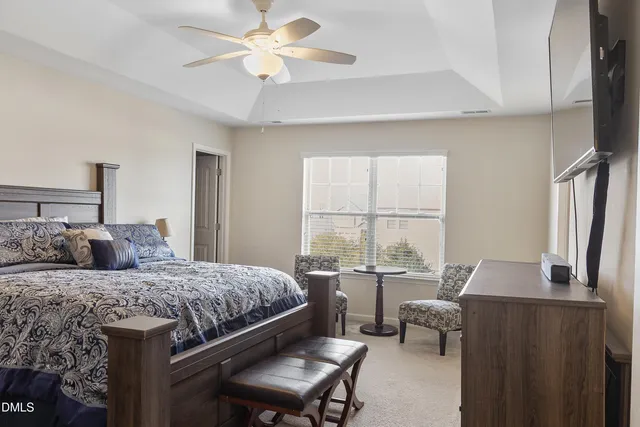 a bedroom with a large bed and a window