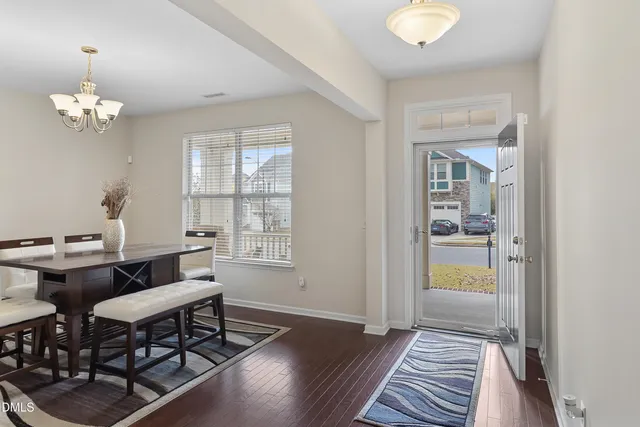 a view of a dining room with furniture window and wooden floor