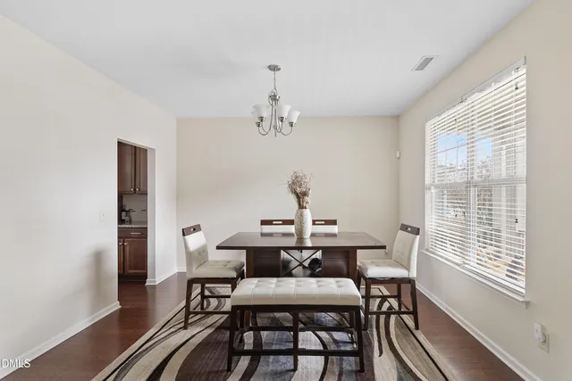 a dining room with furniture and window