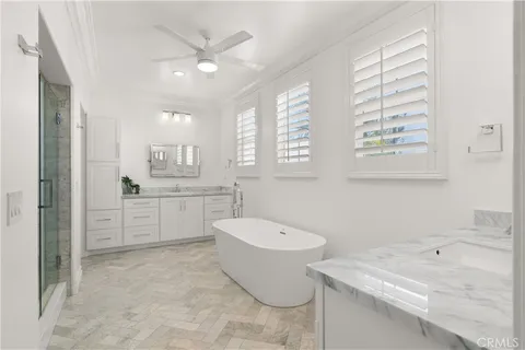 a bathroom with a granite countertop sink mirror bathtub and toilet