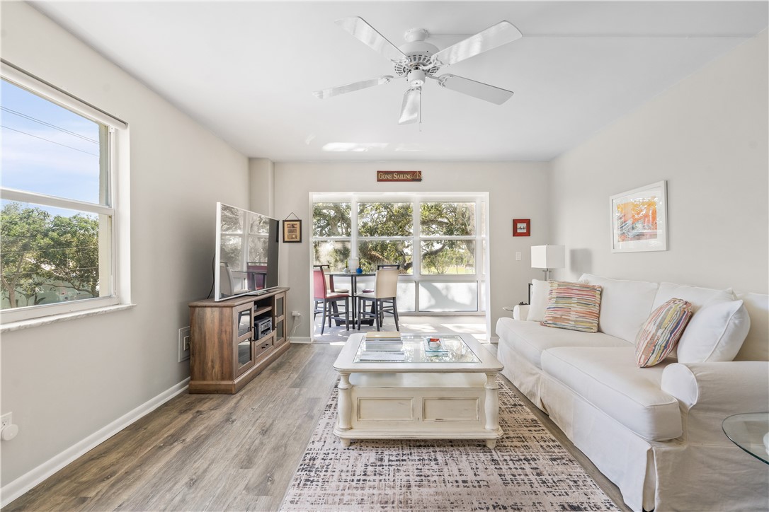 275 Date Palm Road, Unit 307 Vero Beach, FL 32963 - Photo 1 of 36 a living room with furniture and a flat screen tv