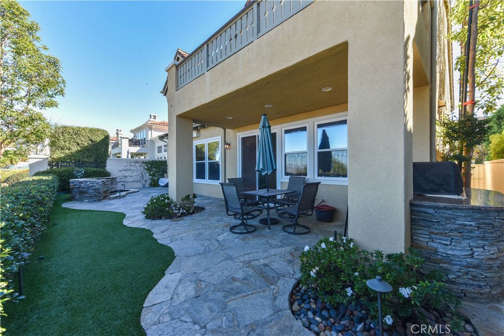 21 Marisol Newport Coast, CA 92657 - Photo 34 of 35 a view of a patio with table and chairs potted plants and floor to ceiling window