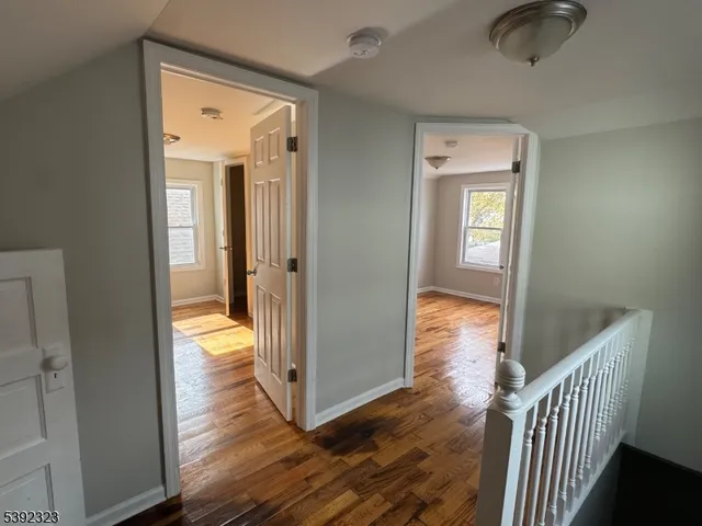 wooden floor with a bedroom and windows
