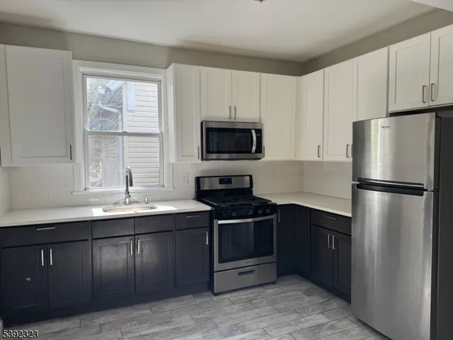a kitchen with a sink stove and refrigerator