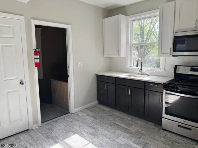 a kitchen with a sink stove and refrigerator