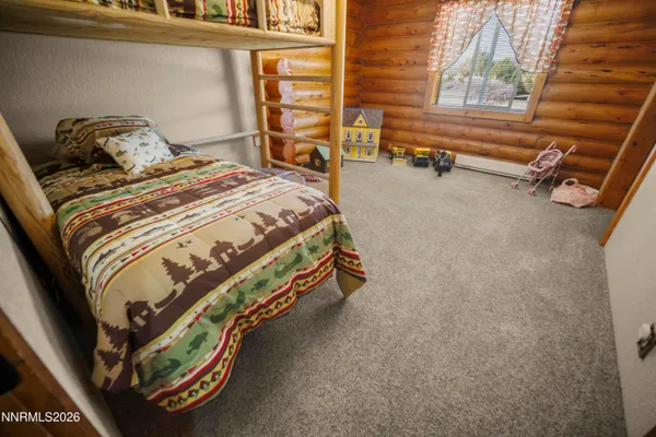 a bed sitting in a bedroom next to a window