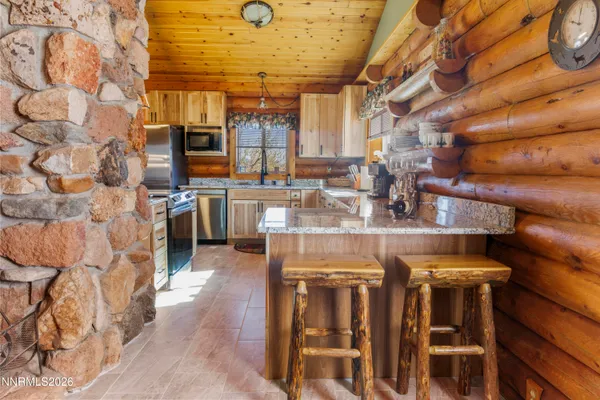 a kitchen with a table and chairs