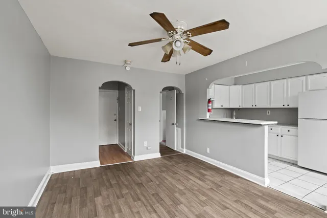 a kitchen with stainless steel appliances a refrigerator sink and white cabinets