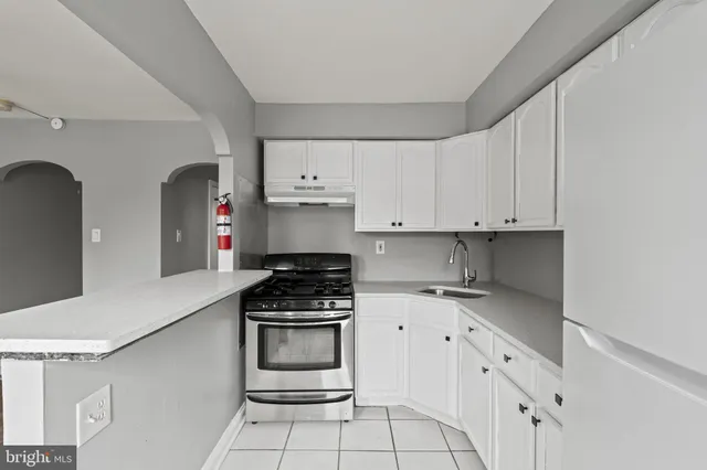 a kitchen with a refrigerator and cabinets
