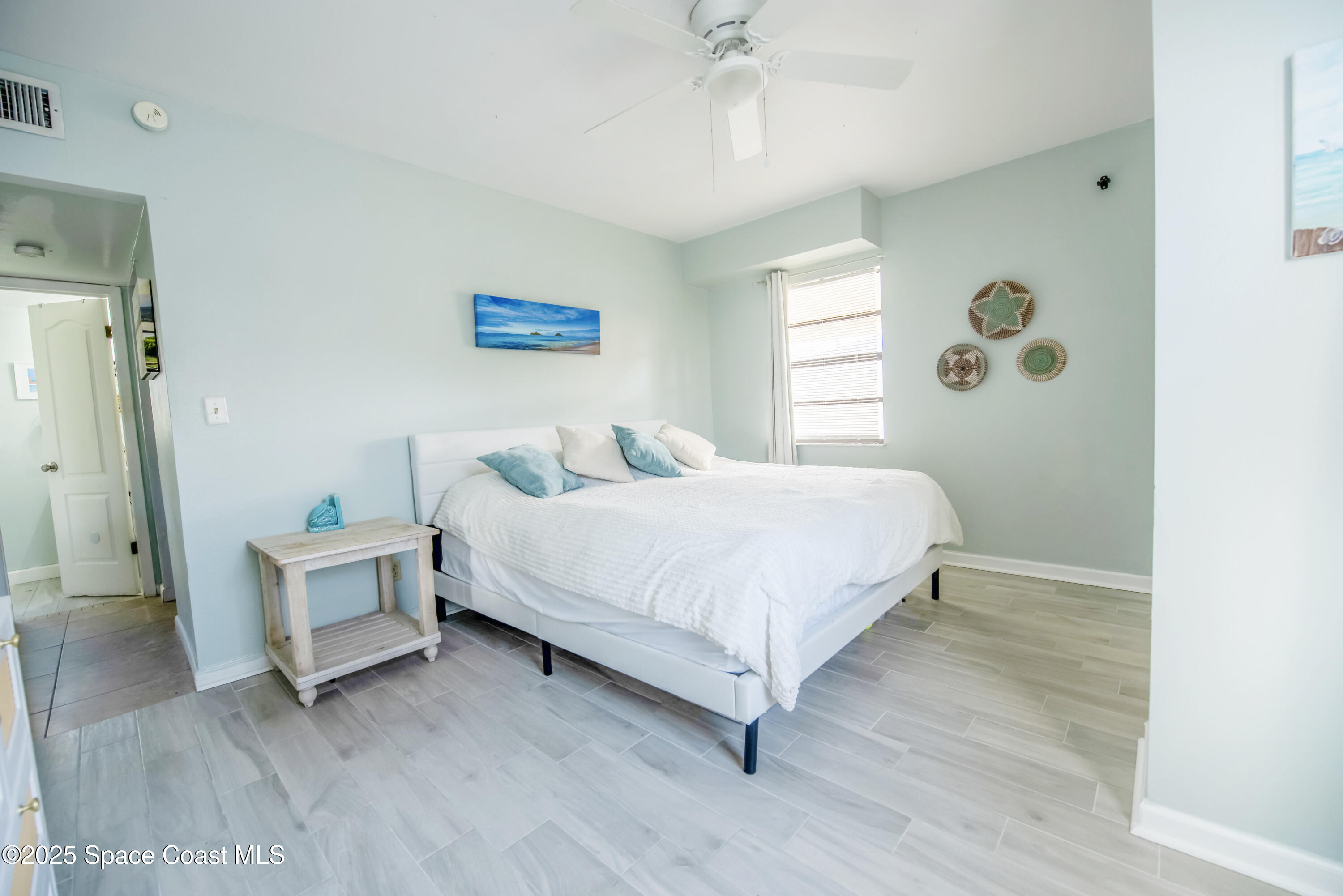 142 Atlantic Avenue Indialantic, FL 32903 - Photo 15 of 27 a bedroom with a bed and a window