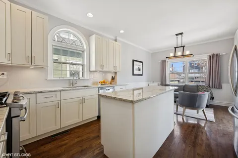 a kitchen with stainless steel appliances granite countertop a sink and cabinets