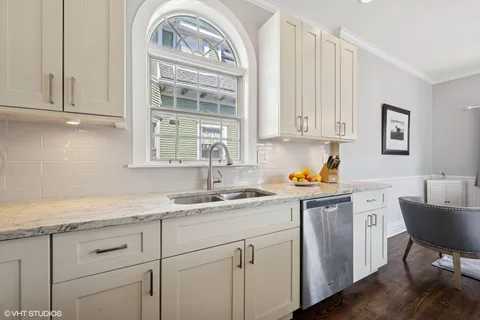 a kitchen with stainless steel appliances granite countertop a sink stove and cabinets