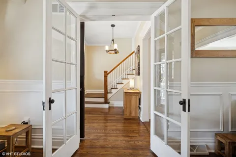 a view of entryway and hall with wooden floor