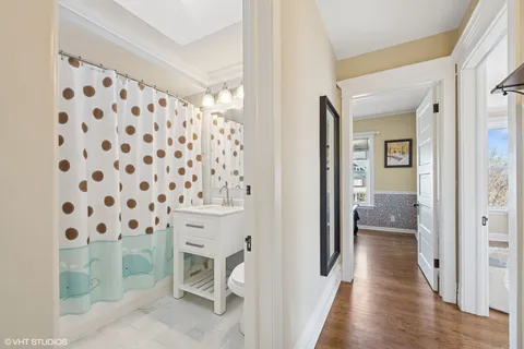 a bathroom with a sink toilet and shower