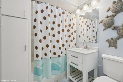 a bedroom with bed and painting on the wall