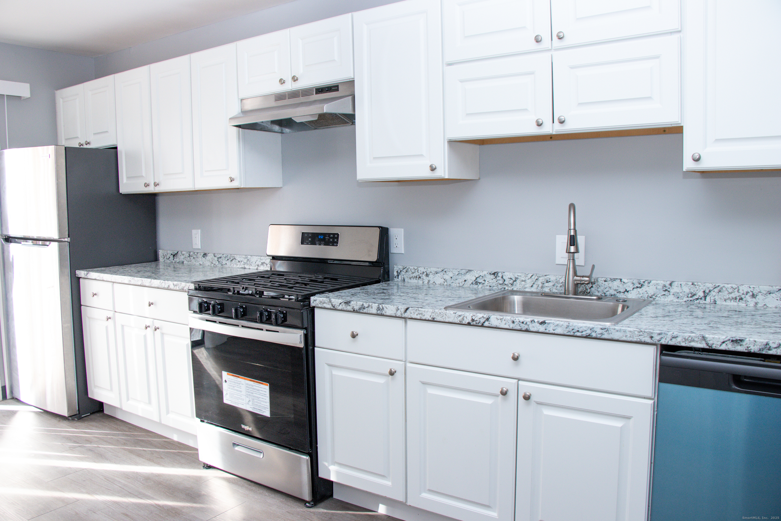 98 Kaye Vue Drive Hamden, CT 06514 - Photo 2 of 7 a kitchen with stainless steel appliances granite countertop a sink and a stove