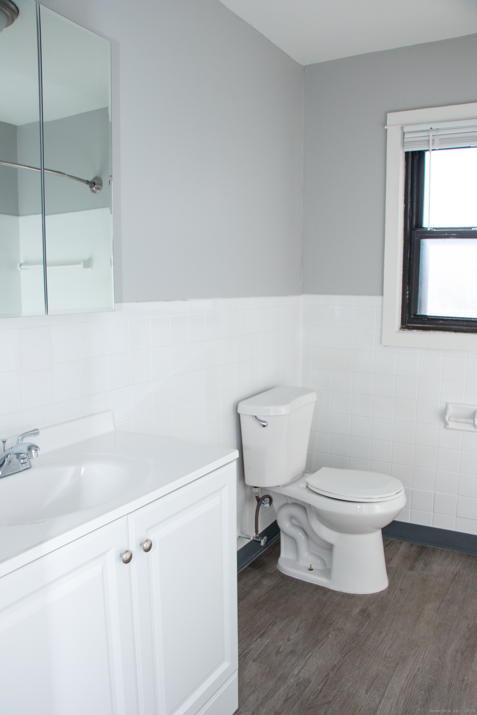 98 Kaye Vue Drive Hamden, CT 06514 - Photo 5 of 7 a bathroom with a toilet a sink and a window