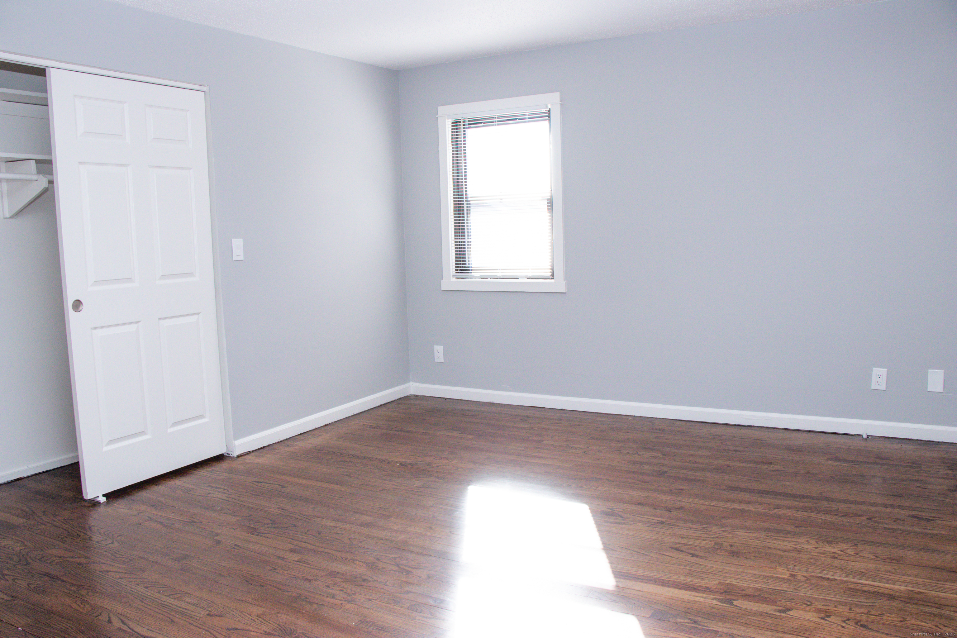 98 Kaye Vue Drive Hamden, CT 06514 - Photo 6 of 7 a view of an empty room with wooden floor and a window