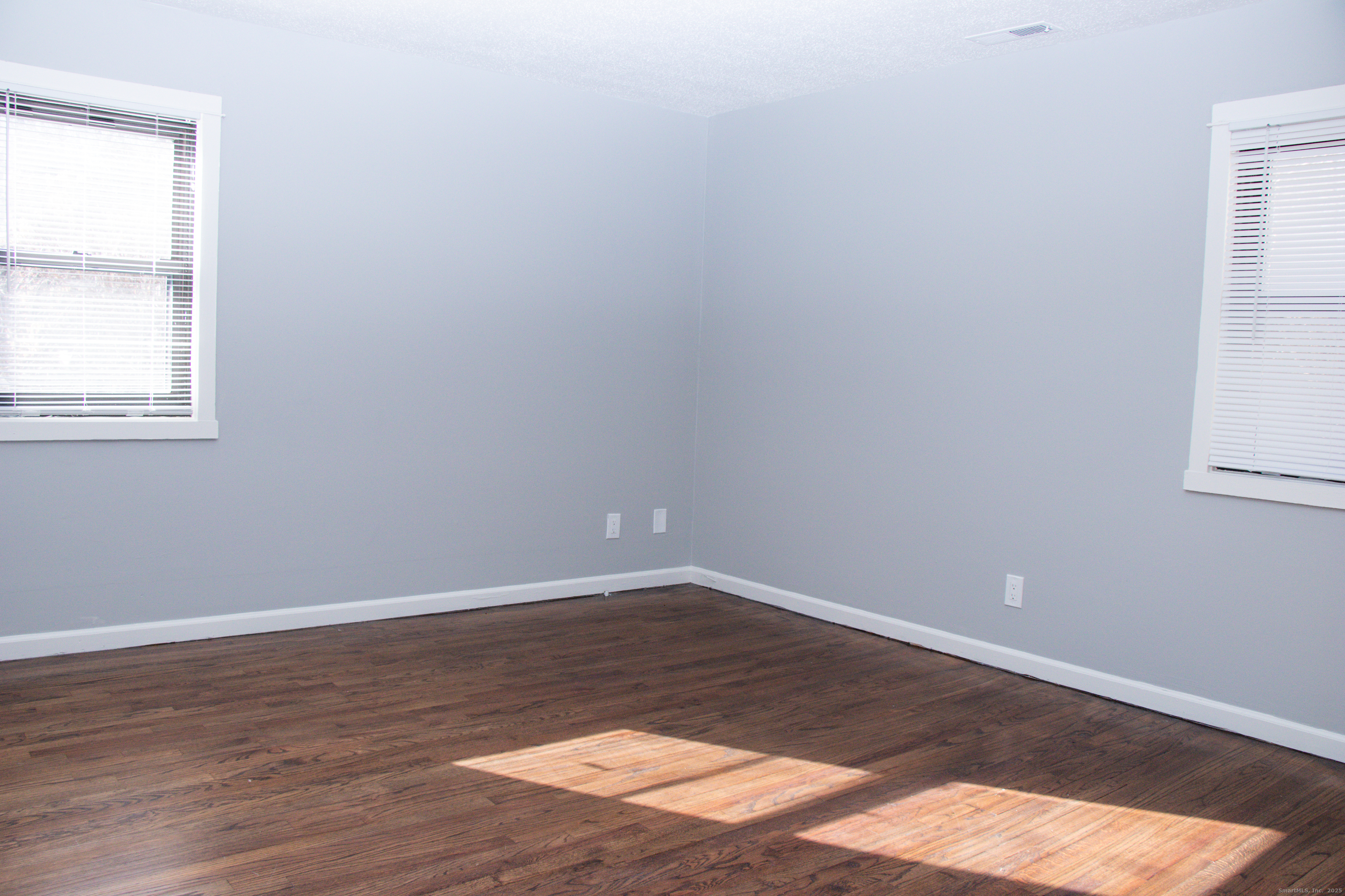 98 Kaye Vue Drive Hamden, CT 06514 - Photo 7 of 7 a view of an empty room with wooden floor and a window