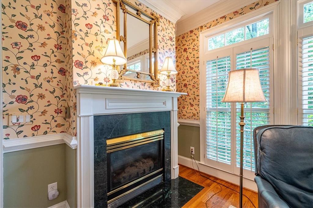 416 McDaniel Street Monroe, GA 30655 - Photo 13 of 69 a living room with a fireplace and a large window