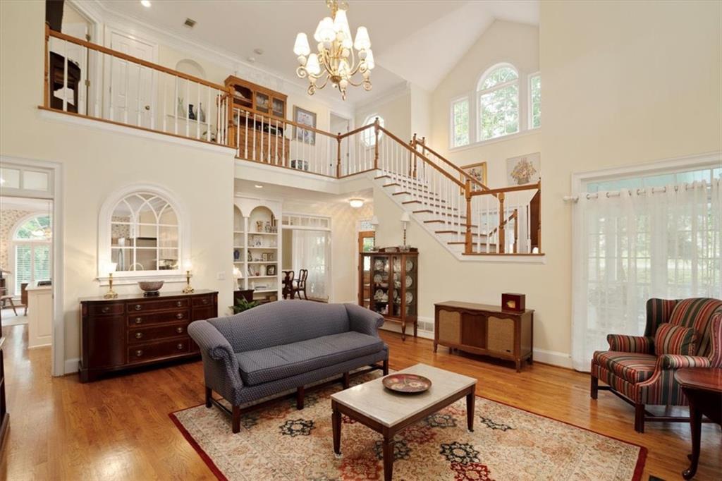 416 McDaniel Street Monroe, GA 30655 - Photo 17 of 69 a living room with furniture a fireplace and a chandelier