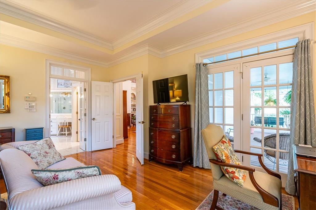 416 McDaniel Street Monroe, GA 30655 - Photo 23 of 69 a living room with furniture a flat screen tv and large window
