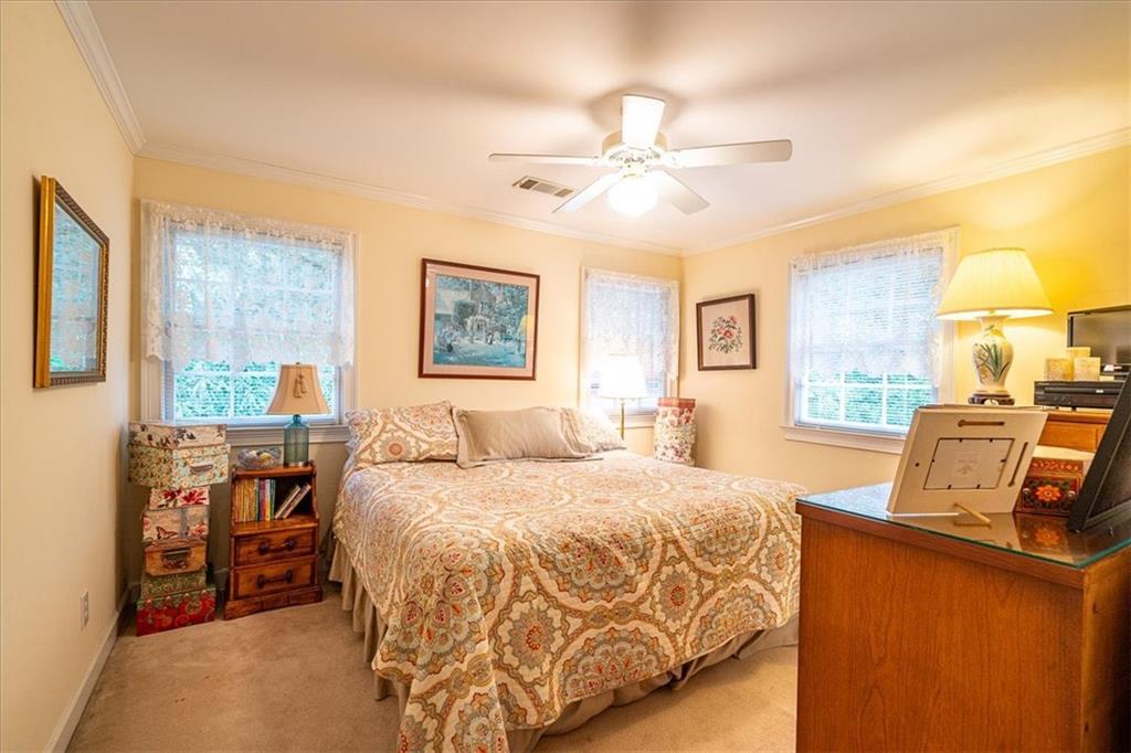 416 McDaniel Street Monroe, GA 30655 - Photo 31 of 69 a bedroom with a large bed and a window