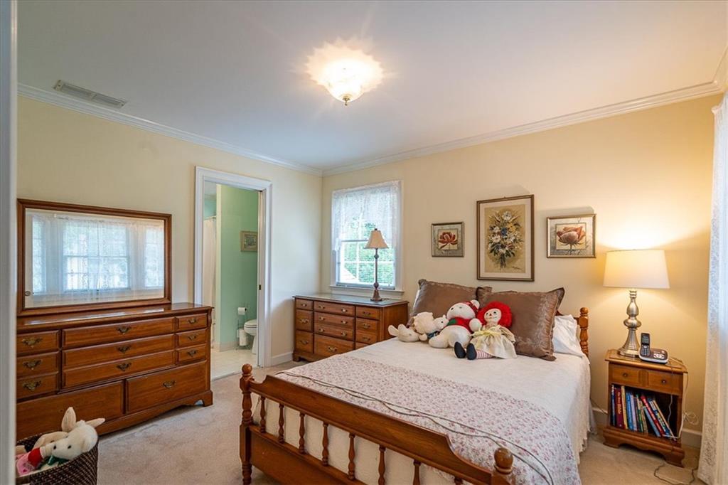 416 McDaniel Street Monroe, GA 30655 - Photo 32 of 69 a bedroom with a bed and wooden floor