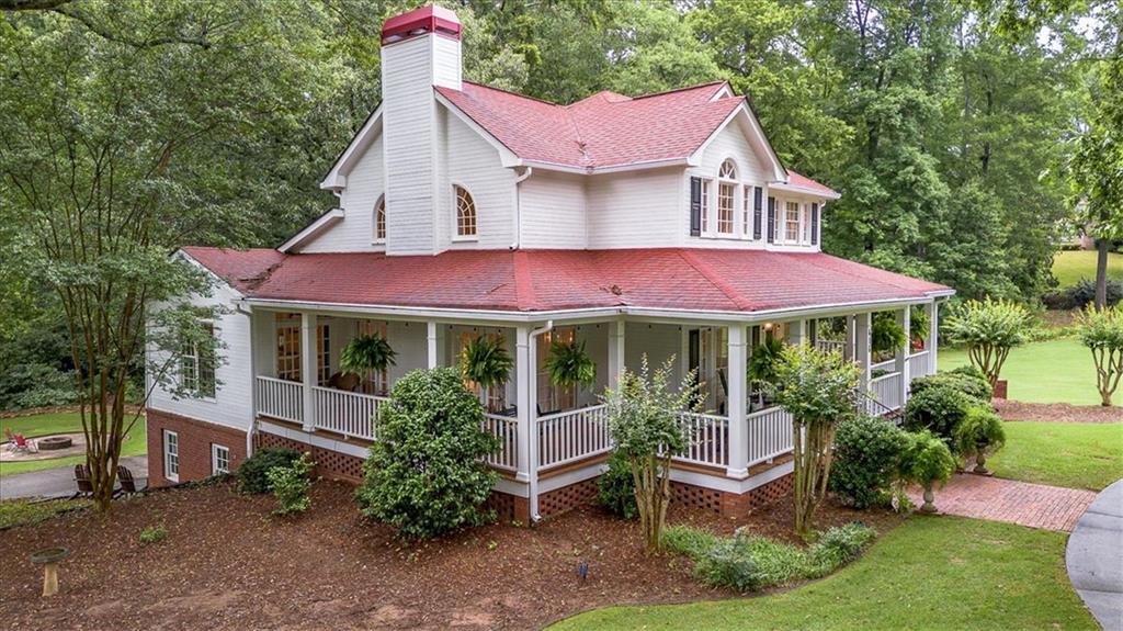 416 McDaniel Street Monroe, GA 30655 - Photo 61 of 69 a view of a house with a yard potted plants and a table