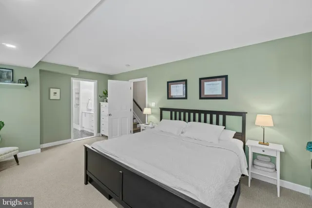 a bedroom with a large bed and a chandelier