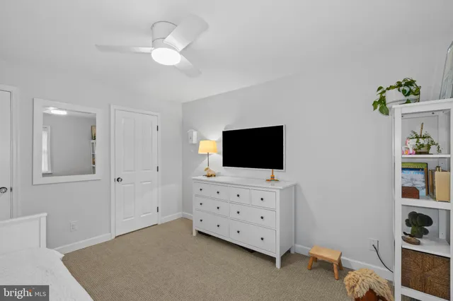 a hotel room with flat screen tv and dresser