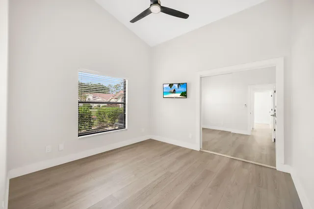 a view of an empty room with wooden floor