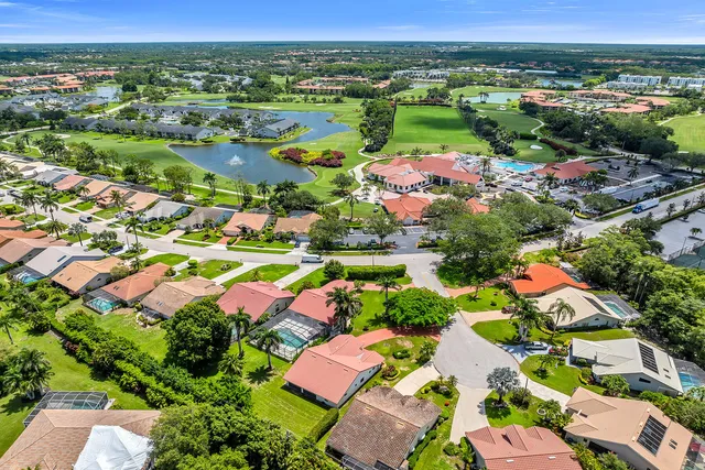an aerial view of residential houses with outdoor space and swimming pool