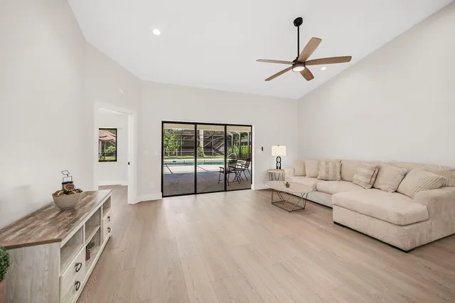 a living room with furniture and ceiling fan