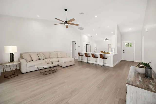 a living room with furniture and a wooden floor