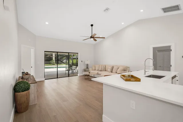 a open kitchen with furniture and chandelier