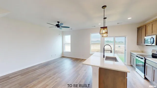 a view of a kitchen with a sink stainless steel appliances and cabinets