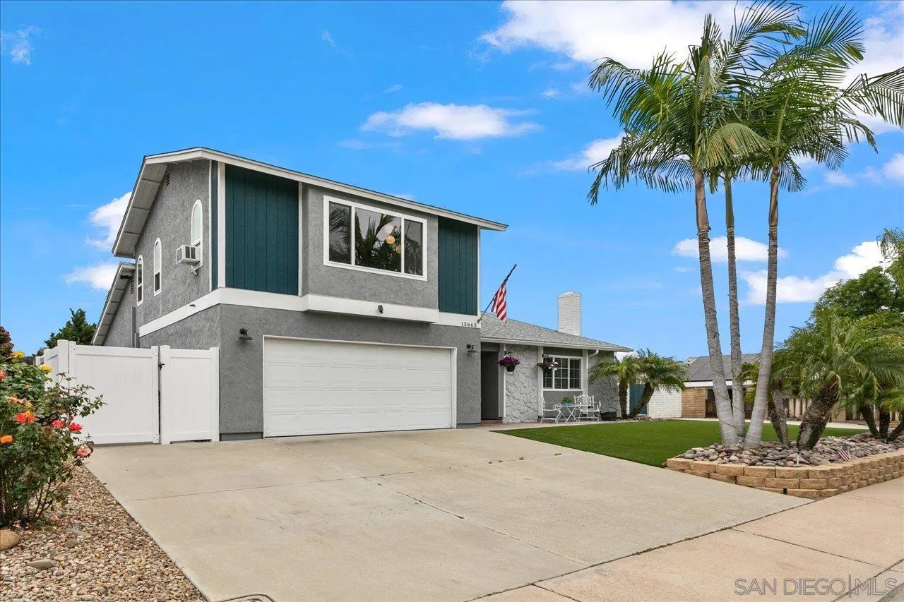 13663 Paseo Del Mar El Cajon, CA 92021 - Photo 2 of 36 a front view of a house with a yard and garage