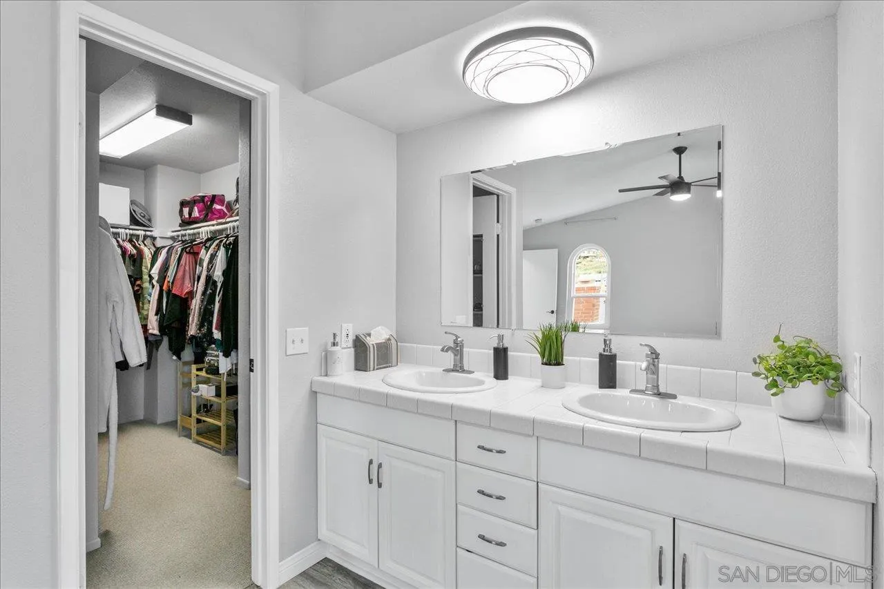13663 Paseo Del Mar El Cajon, CA 92021 - Photo 25 of 36 a bathroom with a double vanity sink and a mirror
