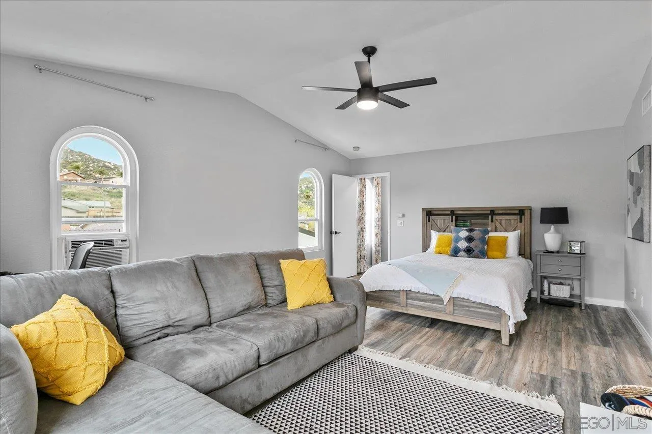 13663 Paseo Del Mar El Cajon, CA 92021 - Photo 26 of 36 a bedroom with a bed couch and window