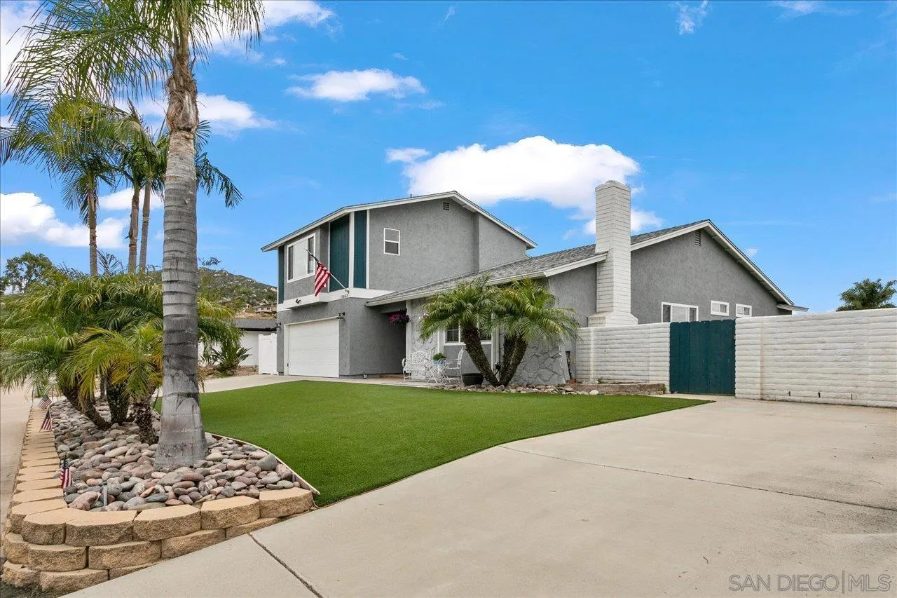 13663 Paseo Del Mar El Cajon, CA 92021 - Photo 3 of 36 a front view of a house with a yard and potted plants
