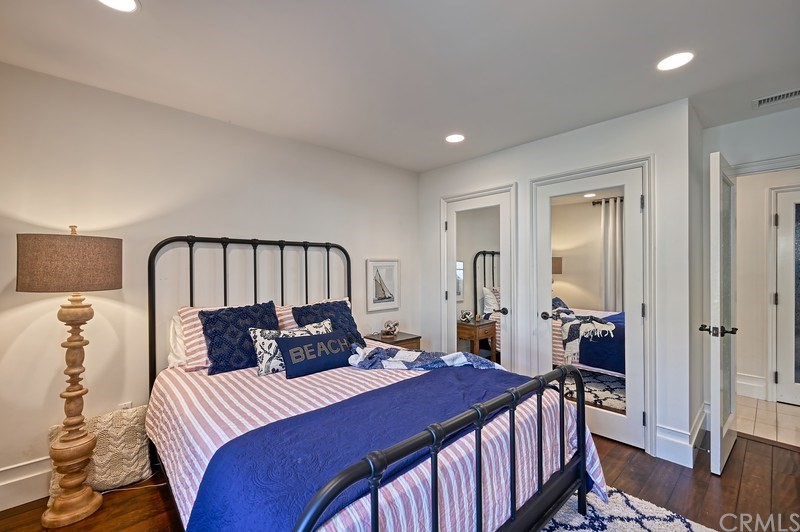 33701 Windjammer Drive Dana Point, CA 92629 - Photo 23 of 35 a bedroom with a bed and wooden floor