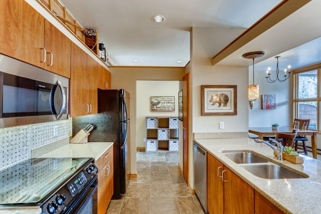 2017 Soda Ridge Road, Unit 1938 Keystone, CO 80435 - Photo 11 of 31 a kitchen with granite countertop a sink and a stove top oven