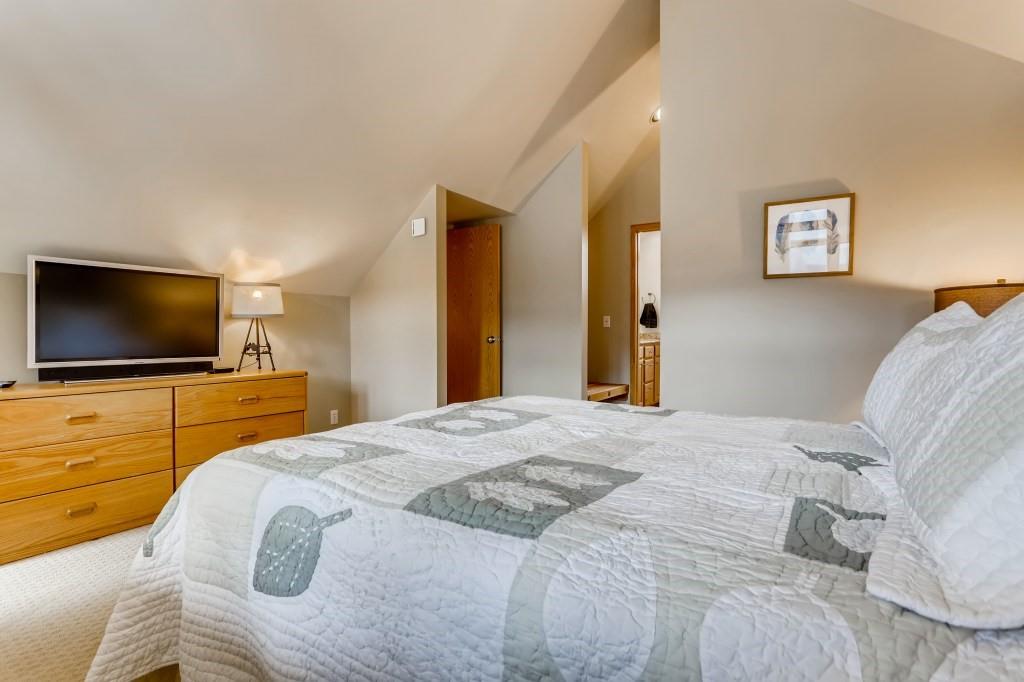 2017 Soda Ridge Road, Unit 1938 Keystone, CO 80435 - Photo 14 of 31 a bedroom with a flat screen tv and a bed