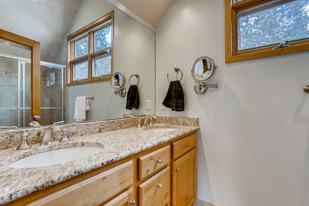 2017 Soda Ridge Road, Unit 1938 Keystone, CO 80435 - Photo 16 of 31 a bathroom with a granite countertop sink and a mirror
