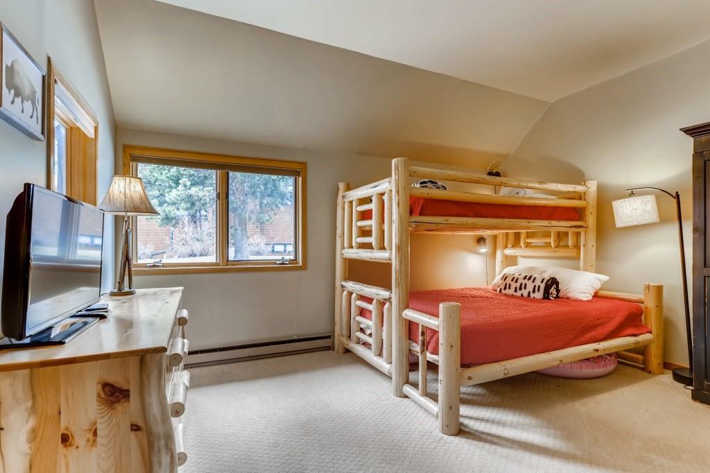 2017 Soda Ridge Road, Unit 1938 Keystone, CO 80435 - Photo 17 of 31 a bedroom with a bed and a flat tv screen next to a window